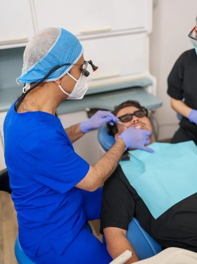 Dentist and dental assistant with a patient at Dentistry on Guelph dental office.