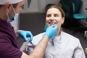 The image depicts a diverse group of dental professionals discussing the Canadian Dental Care Plan (CDCP) in a modern clinic setting, emphasizing the importance of understanding the range of dental services covered, such as preventive care. This collaboration among oral health providers highlights the goal of making comprehensive oral health care accessible to eligible Canadian residents.