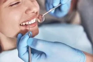 A smiling patient in a dental chair during a check-up