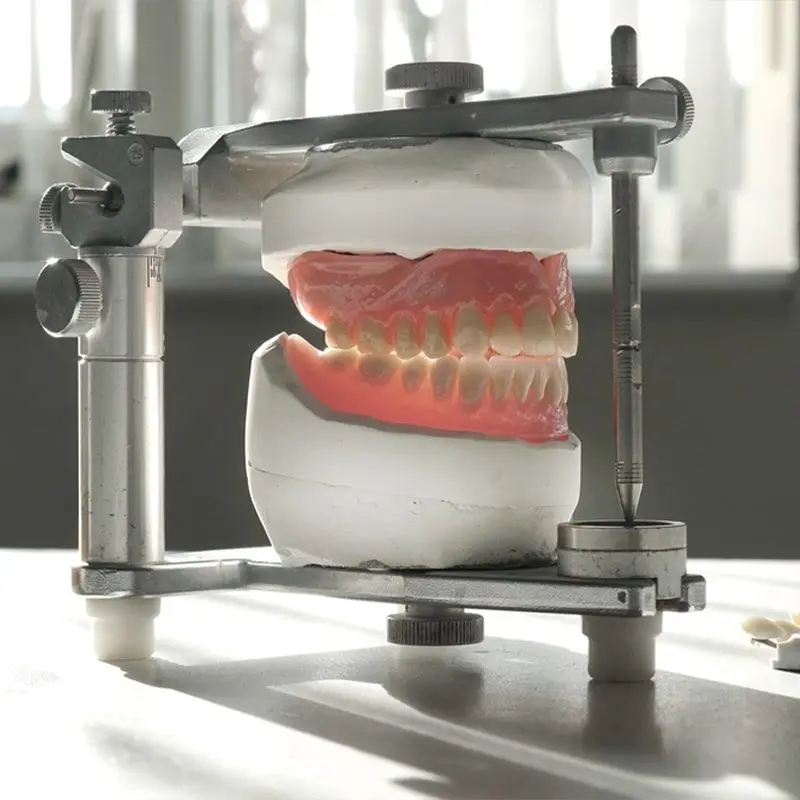 A full denture on a dental articulator in a lab